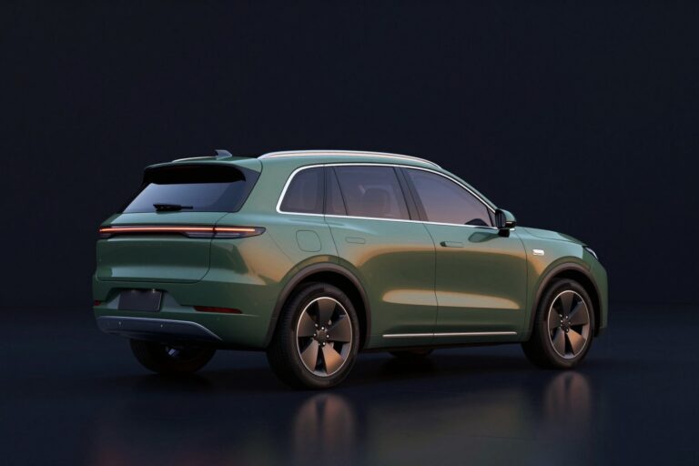Moss green seven-seater SUV seen from behind, in a dark showroom