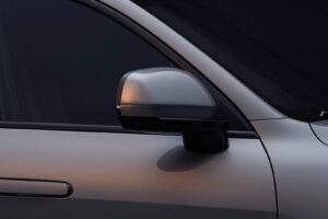The side mirror on the graphite grey door of the electric SUV