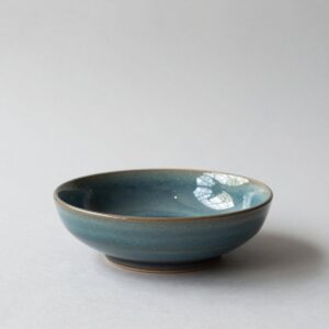 Low, wide serving bowl in a glossy deep-teal glaze that breaks to brown at the rim