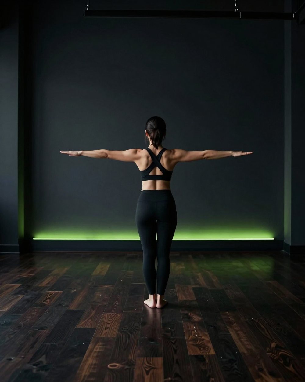 A woman holding a warrior yoga pose in a quiet studio