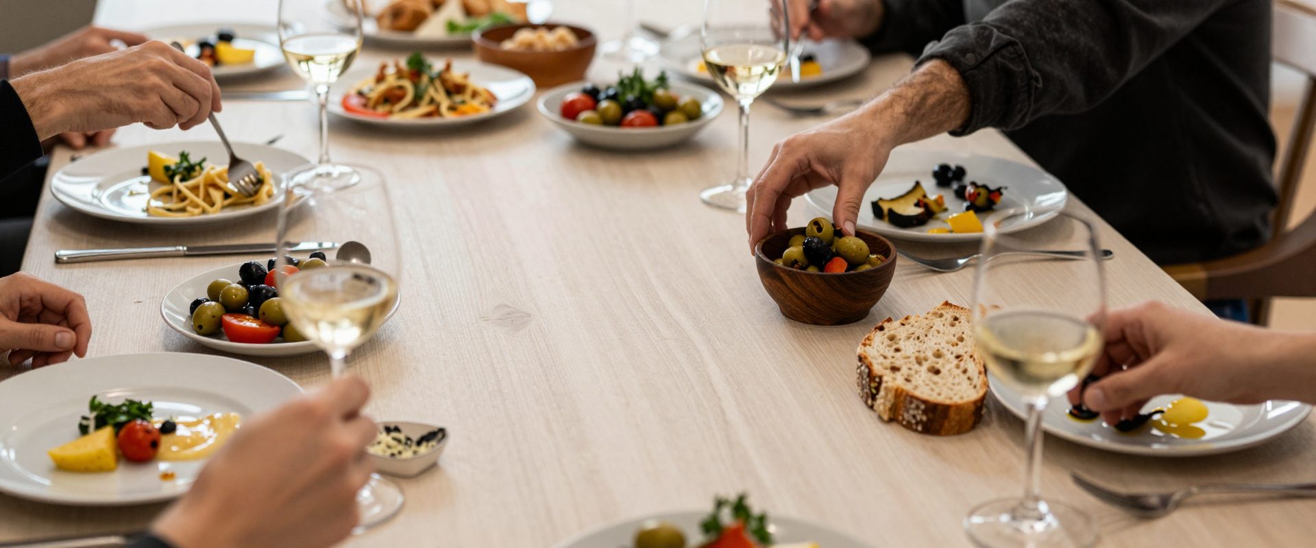 A long table of shared Italian dishes seen from above